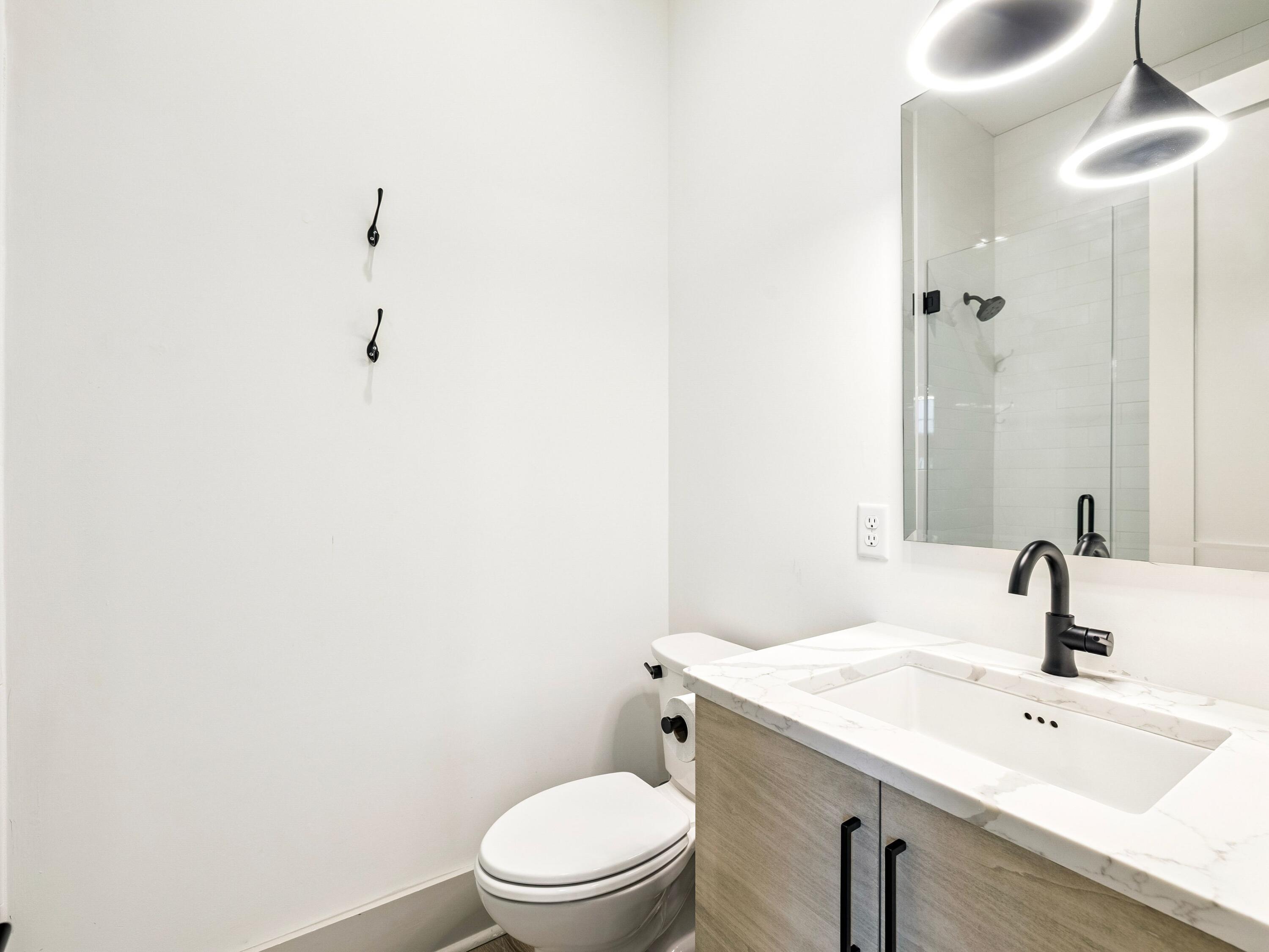 80 Grande Pointe Drive Inlet Beach, FL 32461 - Photo 33 of 68 a bathroom with a sink a toilet and mirror