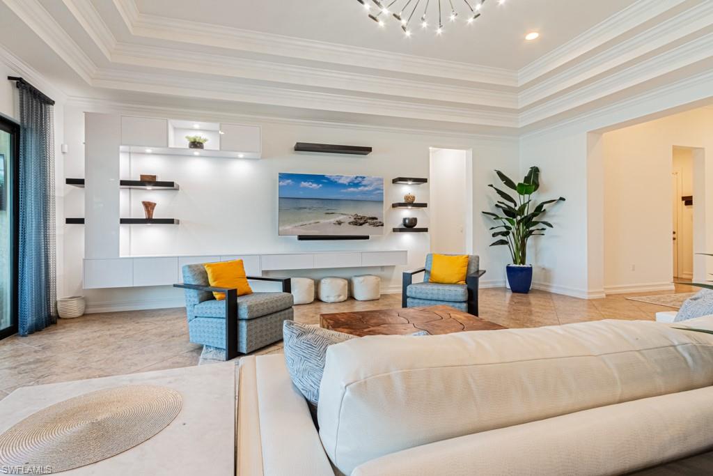 9380 Glenforest Drive Naples, FL 34120 - Photo 13 of 49 a living room with stainless steel appliances kitchen island granite countertop furniture and a rug