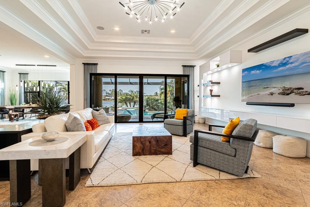 9380 Glenforest Drive Naples, FL 34120 - Photo 2 of 49 a living room with furniture and a large window