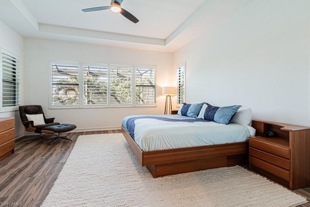 9380 Glenforest Drive Naples, FL 34120 - Photo 21 of 49 a spacious bedroom with a bed and a couch