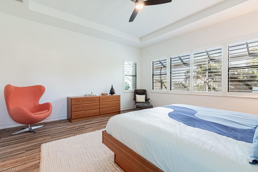 9380 Glenforest Drive Naples, FL 34120 - Photo 22 of 49 a bedroom with furniture and a large window