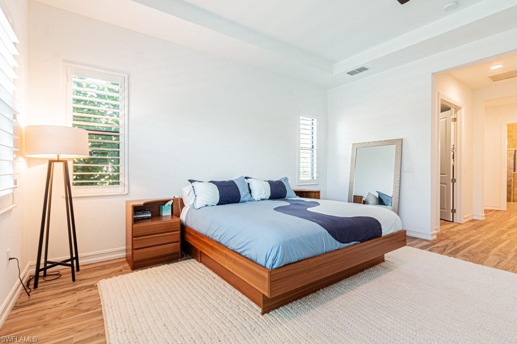 9380 Glenforest Drive Naples, FL 34120 - Photo 23 of 49 a bedroom with a bed and a window
