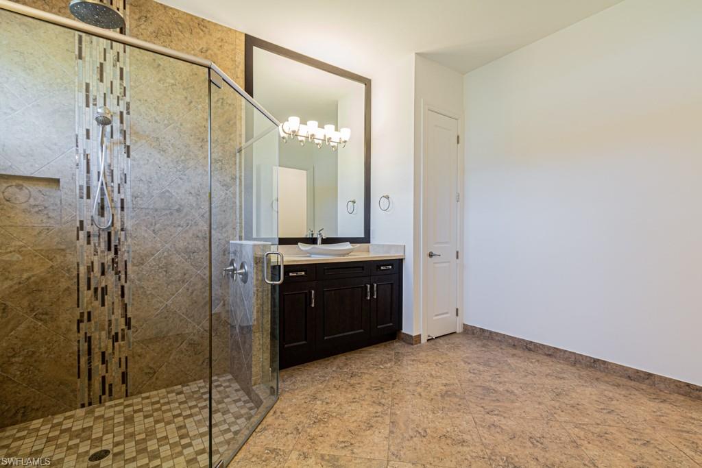 9380 Glenforest Drive Naples, FL 34120 - Photo 26 of 49 a bathroom with a shower and a sink