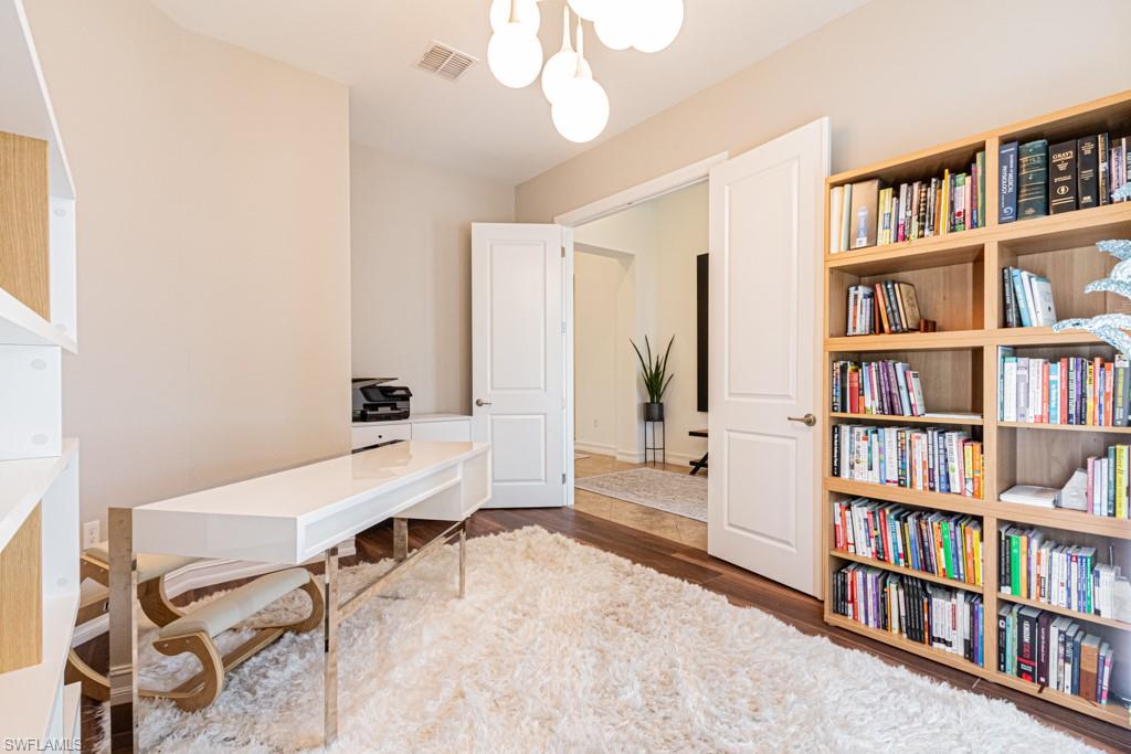 9380 Glenforest Drive Naples, FL 34120 - Photo 29 of 49 a room with a book shelf and a window