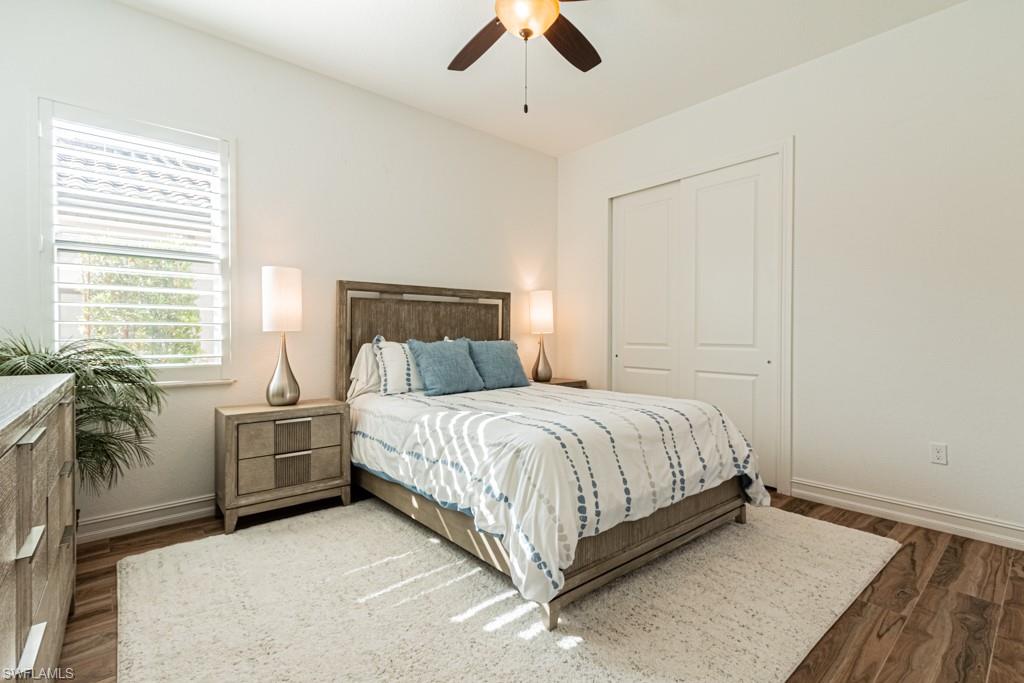 9380 Glenforest Drive Naples, FL 34120 - Photo 31 of 49 a bedroom with a bed and ceiling fan