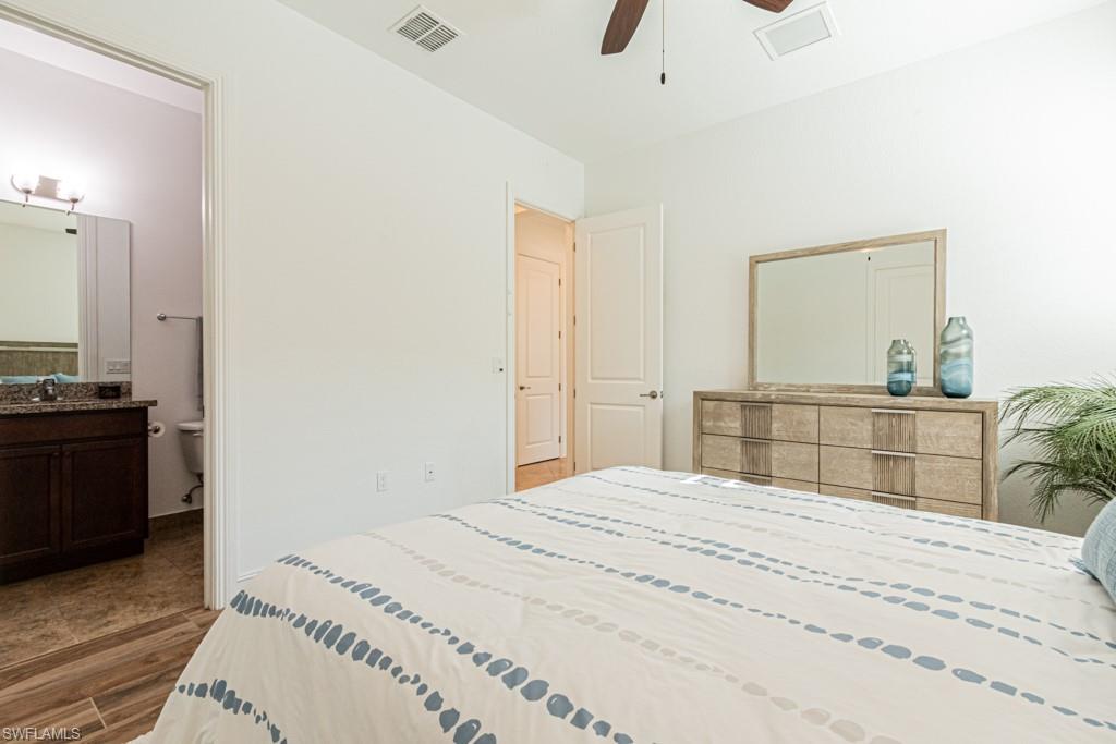 9380 Glenforest Drive Naples, FL 34120 - Photo 33 of 49 a bedroom with a bed and a dresser