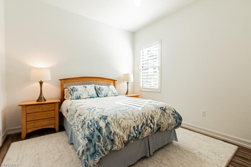 9380 Glenforest Drive Naples, FL 34120 - Photo 35 of 49 a bedroom with a bed and a window