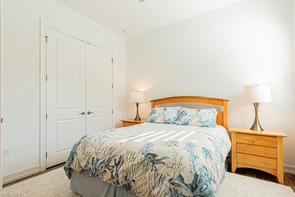 9380 Glenforest Drive Naples, FL 34120 - Photo 36 of 49 a bedroom with a bed and a night stand