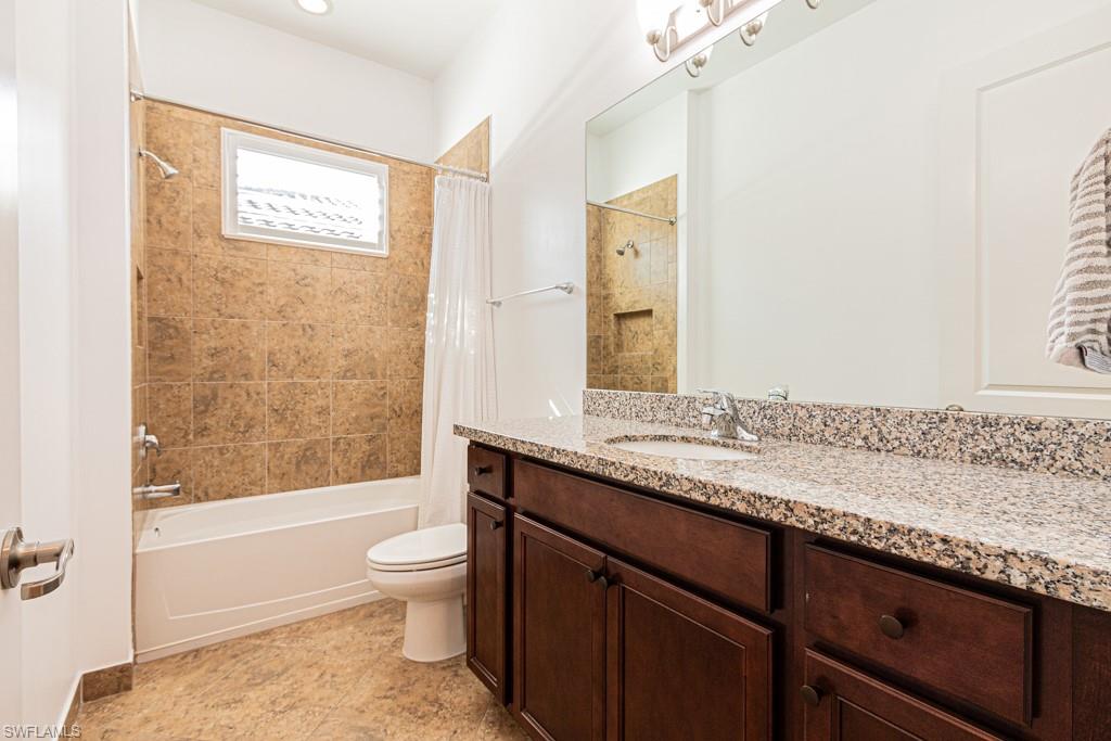 9380 Glenforest Drive Naples, FL 34120 - Photo 37 of 49 a bathroom with a granite countertop sink a toilet and shower