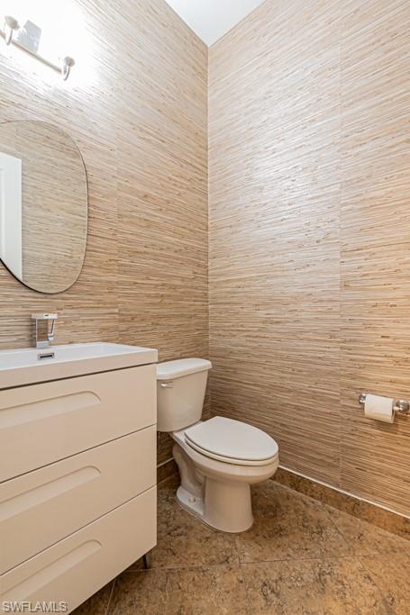 9380 Glenforest Drive Naples, FL 34120 - Photo 38 of 49 a bathroom with a toilet and a sink