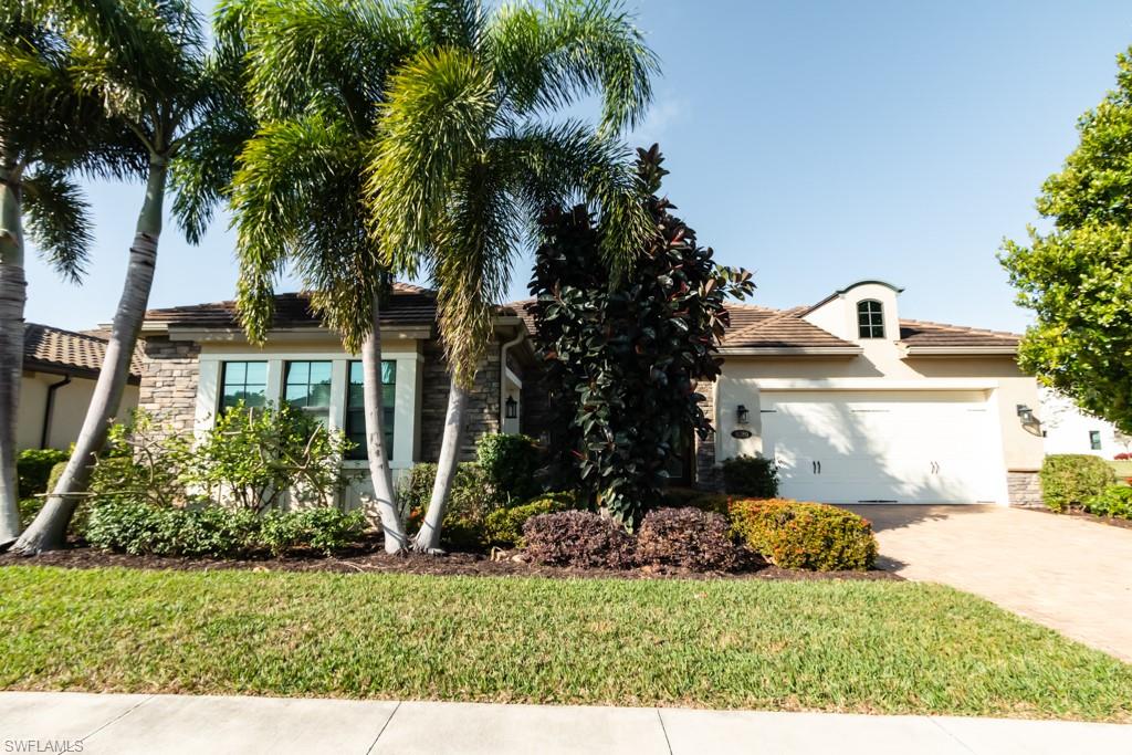 9380 Glenforest Drive Naples, FL 34120 - Photo 4 of 49 a front view of a house with garden
