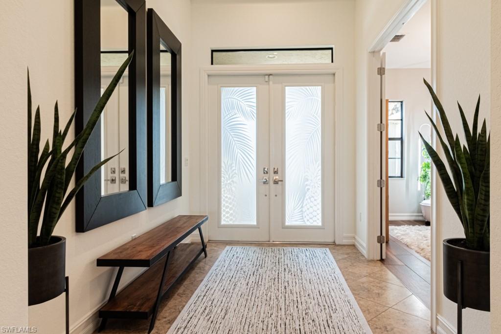 9380 Glenforest Drive Naples, FL 34120 - Photo 6 of 49 a view of a hallway with furniture and entryway