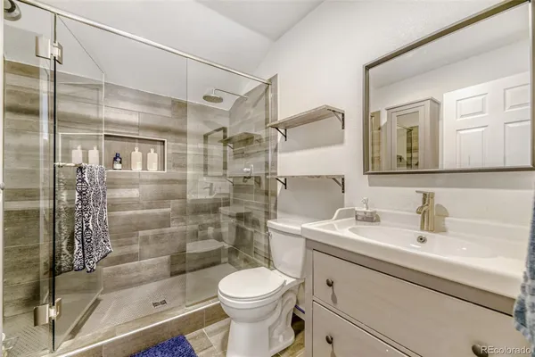 a bathroom with a sink toilet and shower