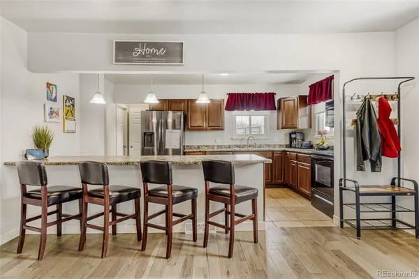 a kitchen with stainless steel appliances granite countertop a sink refrigerator and microwave
