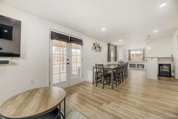 a dining room with furniture and wooden floor