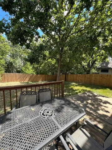 a view of a roof deck with wooden floor and fence