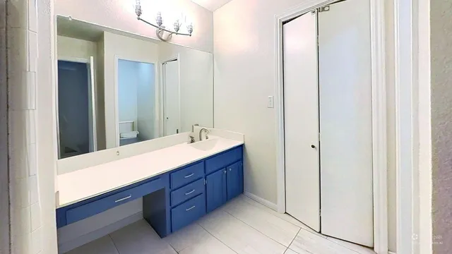 a bathroom with a sink vanity and mirror