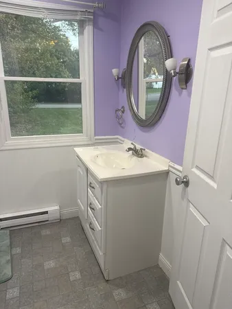 a utility room with a sink and a mirror