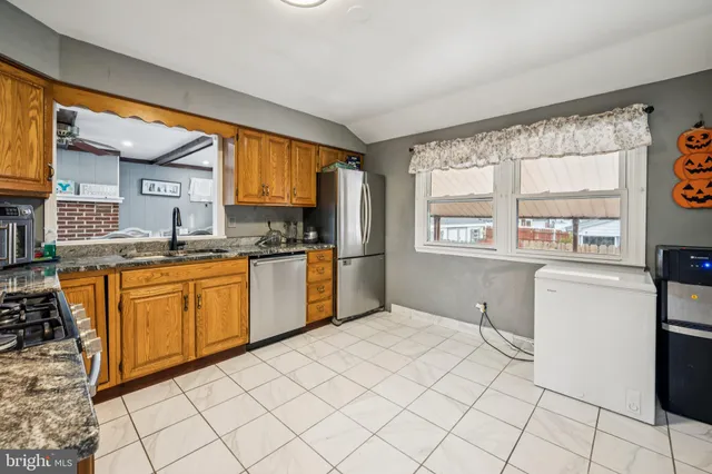 a kitchen with stainless steel appliances a refrigerator and a sink