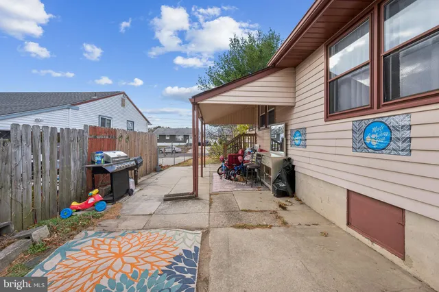 a view of a house with a patio and a yard