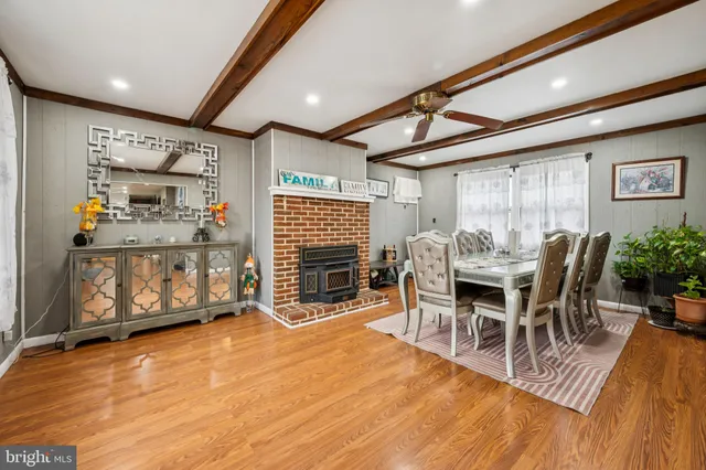 a dining room with furniture and wooden floor