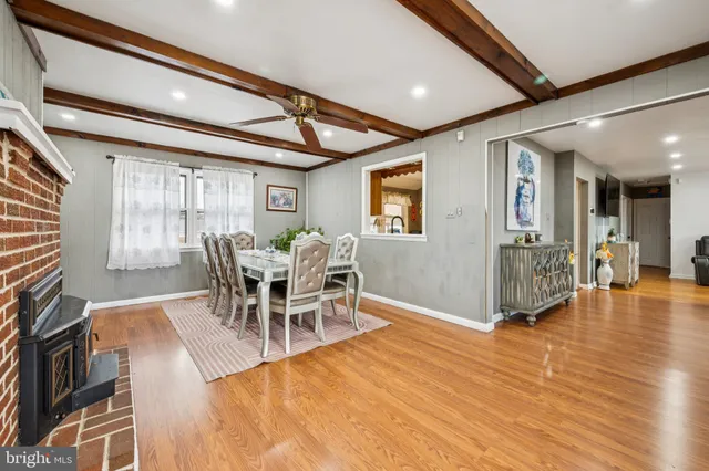 a dining room with furniture and wooden floor