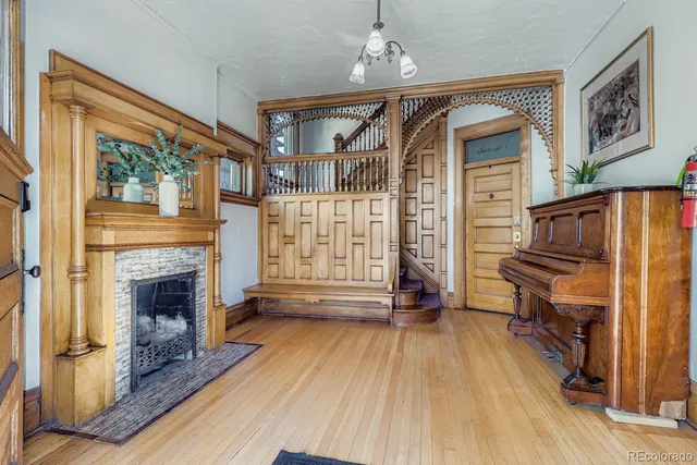 a view of livingroom with furniture wooden floor fireplace and windows
