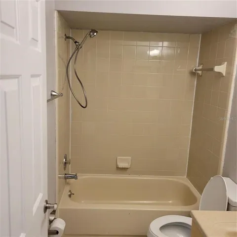 a bathroom with a shower and a bath tub