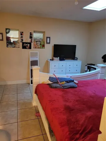 a bedroom with a bed and flat screen tv