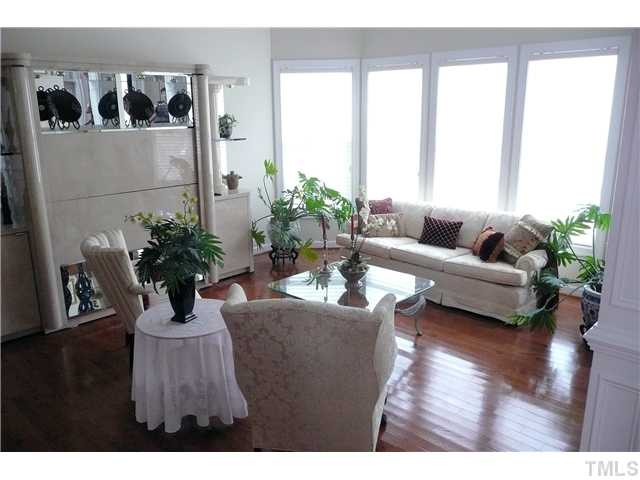 The formal living room is complete with Silhouette Nantucket Shades and crown molding. This bright room makes the perfect sitting room for you and your guests. Living Room