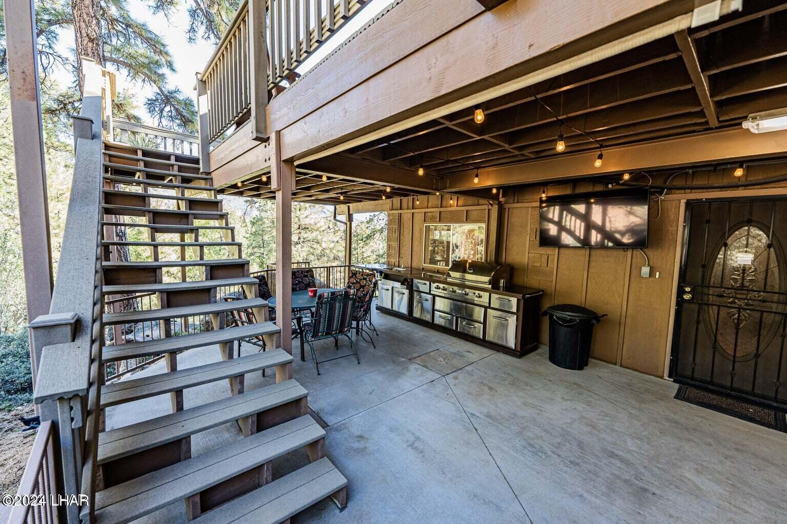 6599 Flag Mine Road Kingman, AZ 86401 - Photo 8 of 63 LOWER LEVEL OUTDOOR KITCHEN & ENTRANCE.