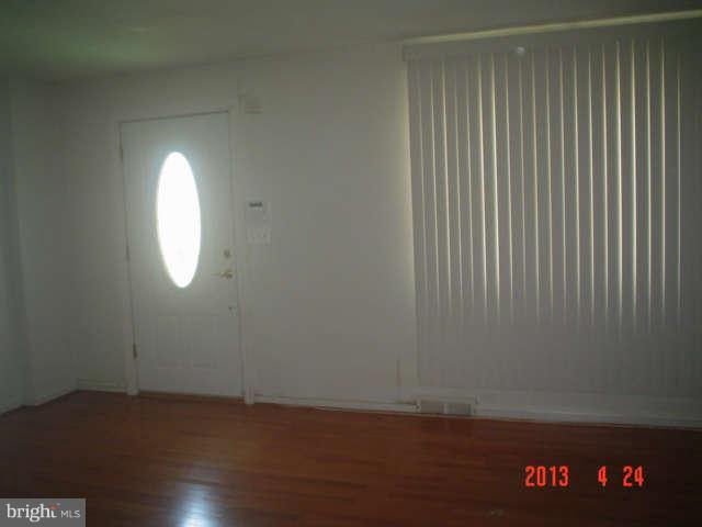 1818 Swansea Road Baltimore, MD 21239 - Photo 3 of 11 an empty room with wooden floor and windows