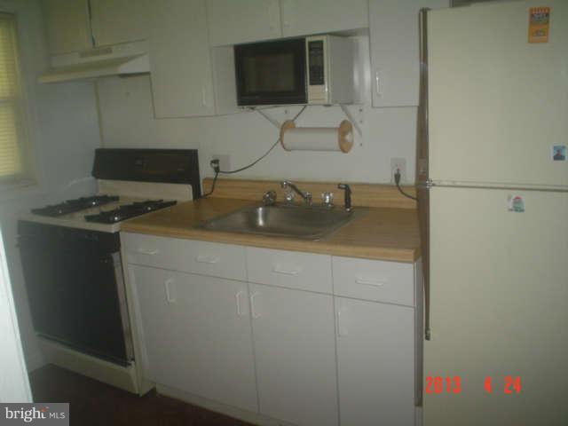 1818 Swansea Road Baltimore, MD 21239 - Photo 5 of 11 a bathroom with a granite countertop sink and a washing machine