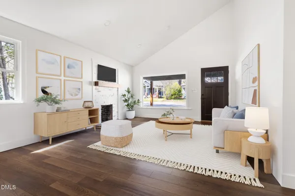 a living room with fireplace furniture and a wooden floor