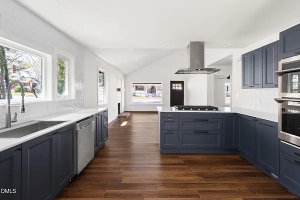 a kitchen with granite countertop a stove and a sink