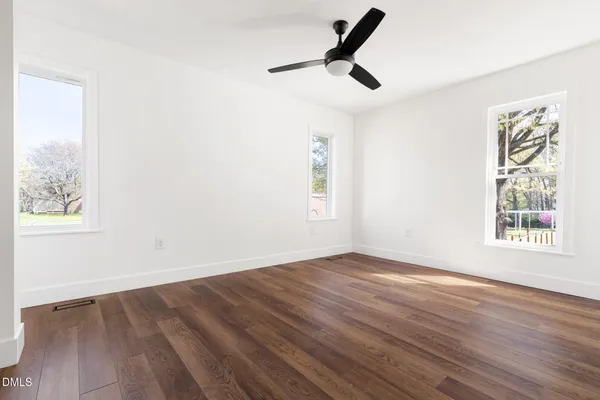 wooden floor in an empty room with a window