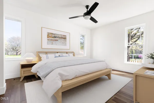 a bedroom with a bed a dresser and a window