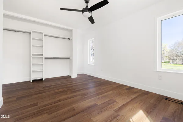 a view of a room with wooden floor and window