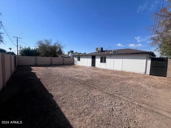 a view of a house with backyard and a garden
