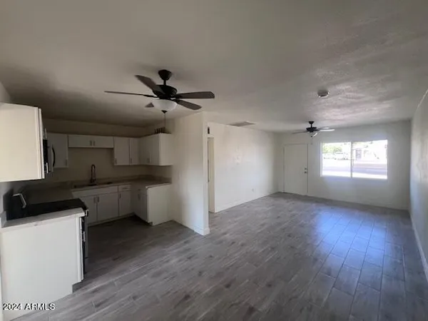 a view of a kitchen with a stove wooden floor and a window