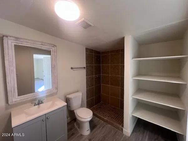 a bathroom with a sink a toilet and a mirror