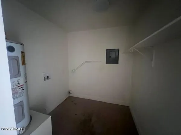 a view of storage and utility room with a fireplace