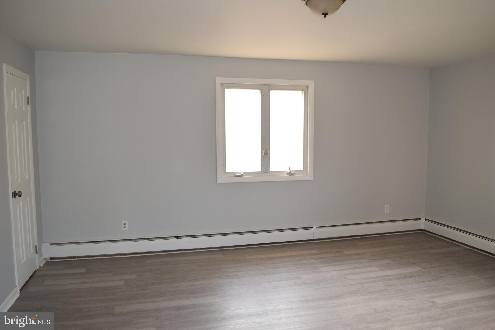 901 Laurel Street, Unit 1 Lebanon, PA 17046 - Photo 2 of 9 wooden floor in an empty room with a window