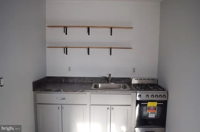 a view of a storage and utility room with washer and dryer