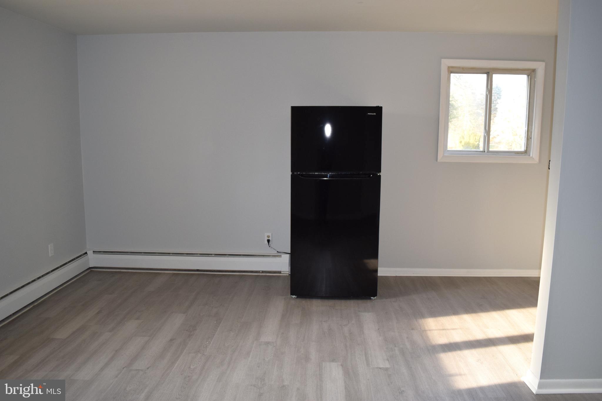 901 Laurel Street, Unit 1 Lebanon, PA 17046 - Photo 5 of 9 an empty room with wooden floor and windows