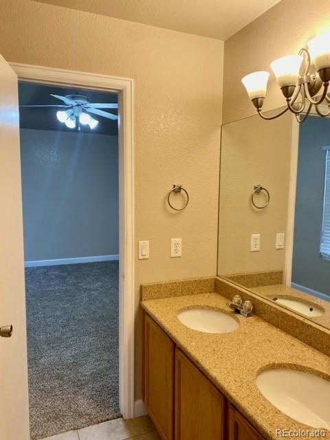 12337 Crystal Downs Road Peyton, CO 80831 - Photo 20 of 22 a bathroom with a granite countertop sink a mirror and a shower