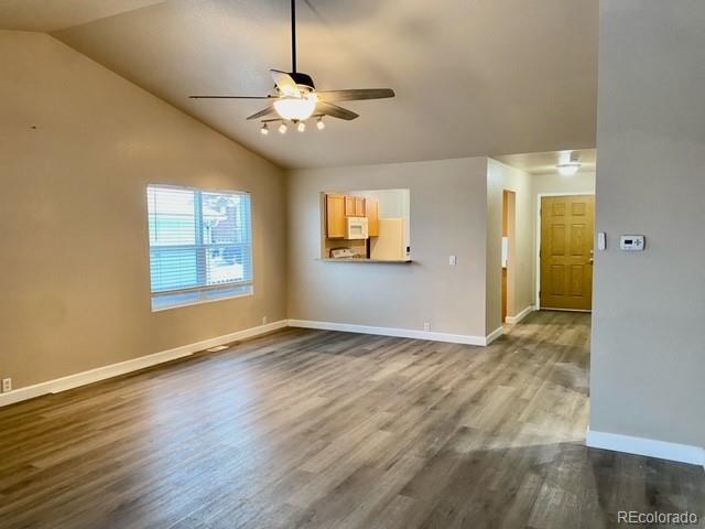 12337 Crystal Downs Road Peyton, CO 80831 - Photo 2 of 22 an empty room with wooden floor chandelier and windows