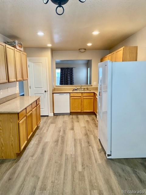 12337 Crystal Downs Road Peyton, CO 80831 - Photo 6 of 22 a large kitchen with kitchen island a stove a sink dishwasher and wooden cabinets