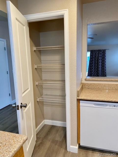 12337 Crystal Downs Road Peyton, CO 80831 - Photo 8 of 22 a view of walk in closet with wooden floor