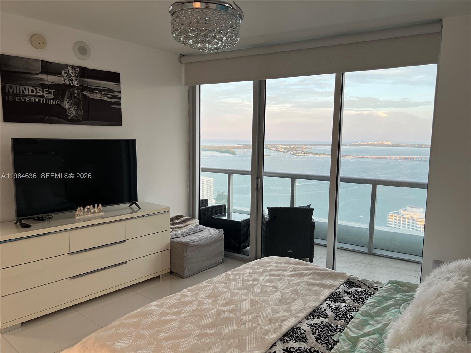 485 Brickell Avenue, Unit 4109 Miami, FL 33131 - Photo 11 of 15 a bedroom with a bed and a television